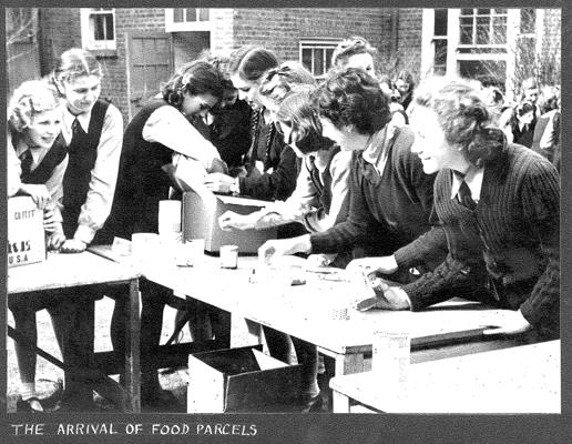 A photograph of Nonsuch students in 1948 unpacking food parcels received from the USA.